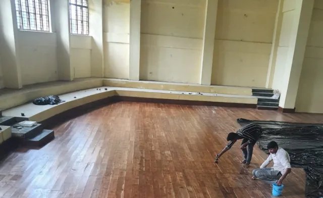 Wooden hall flooring being polished