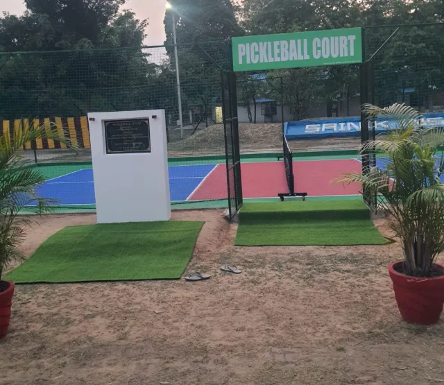 Pickleball court with entrance gate and plaque